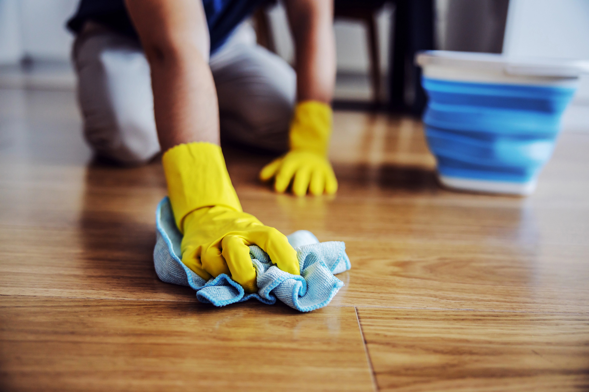 Close-up-of-man-waxing-parquet